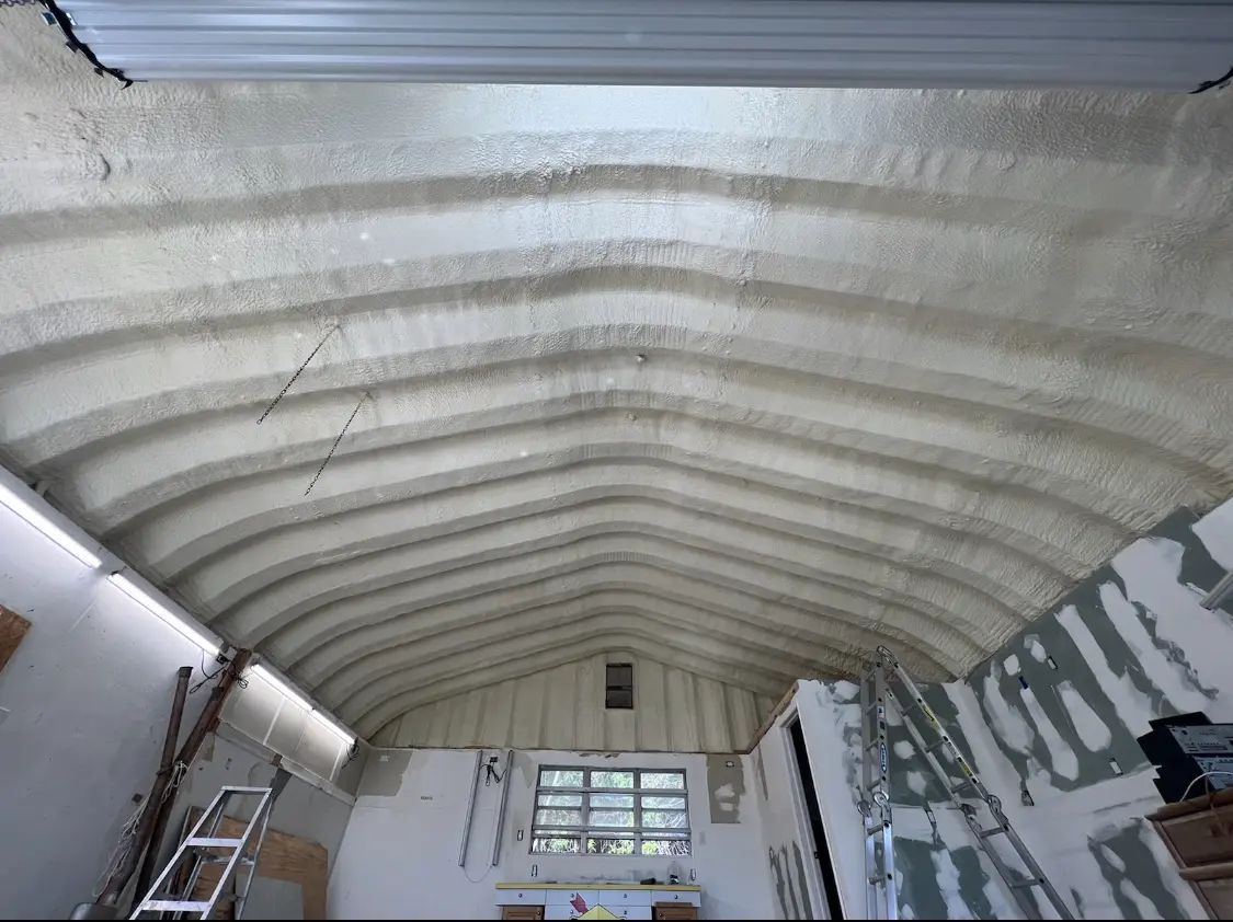 Spray polyurethane foam applied to the underside of a metal roof deck in Albany
